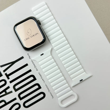 White watch strap with Apple Watch Series on a light gray surface
